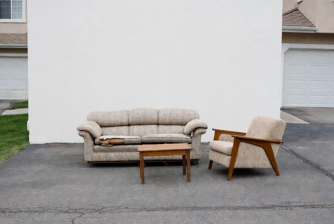 Furniture removal in Calgary — JunkMojo crew hauling a couch from a home